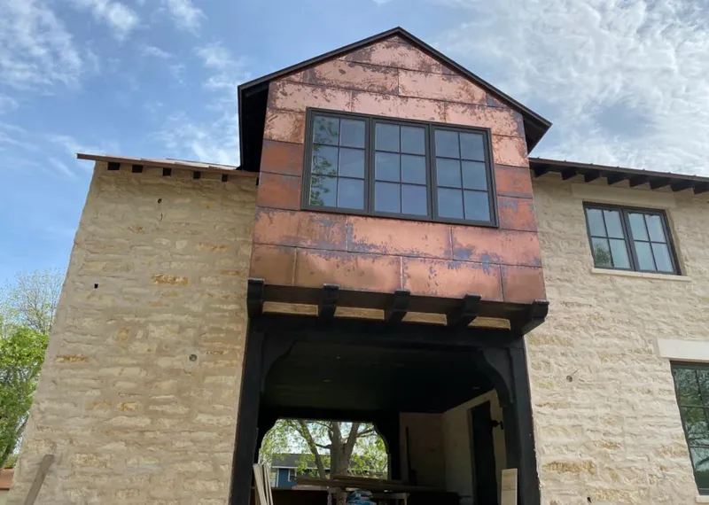 Copper metal panel facade on a stone building for Skylight Installation in Rocky River